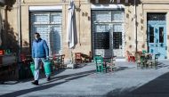 A man wearing a protective face mask carries gas bottles amid the coronavirus disease (COVID-19) outbreak in Nicosia, Cyprus, January 5, 2022. REUTERS/Yiannis Kourtoglou/File Photo