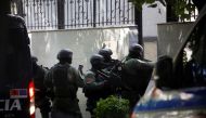 Members of the police special unit enter the Embassy of the Islamic Republic of Iran, as Albania cuts ties with Iran and orders diplomats to leave over cyberattack, in Tirana, Albania, on September 8, 2022. REUTERS/Florion Goga