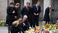 Britain's Princess Eugenie, Peter Phillips, Vice Admiral Sir Timothy Laurence, Zara Tindall, Princess Beatrice and Prince Andrew, Duke of York view the messages and floral tributes left by members of the public, following the passing of Britain's Queen Elizabeth, in Balmoral, Scotland, on September 10, 2022.