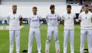 England's Ben Stokes and teammates stand during a minutes silence while wearing black armbands, following the passing of Britain's Queen Elizabeth, before the Third Test match between against South Africa at the The Oval, in London, on September 10, 2022.  Action Images via Reuters/Andrew Boyers