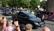 The hearse carrying the coffin of Britain's Queen Elizabeth passes through the village of Ballater, near Balmoral, Scotland, Britain, September 11, 2022. Reuters/Kai Pfaffenbach