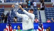 Poland's Iwa Swiatek celebrates with the trophy after defeating Tunisia's Ons Jabeur to win the US Open at the Flushing Meadows, in New York on September 10, 2022  REUTERS/Mike Segar 