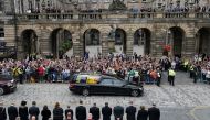 Crowds watch the cortege carrying the coffin of Britain's Queen Elizabeth in Edinburgh, Scotland, on September 11, 2022. Ian Forsyth/Pool via REUTERS