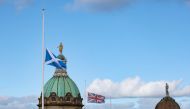 A Scottish flag and a Union Jack fly at half mast following the death of Britain's Queen Elizabeth, in Edinburgh, Scotland, Britain, on September 12, 2022. (REUTERS/Russell Cheyne)