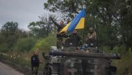 Ukrainian service members stand on a BMP-1 infantry fighting vehicle, amid Russia's attack on Ukraine, near the town of Izium, recently liberated by Ukrainian Armed Forces, in Kharkiv region  on September 14, 2022. REUTERS/Gleb Garanich