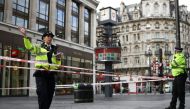 A police officer gestures at the scene where two policemen were stabbed, near Leicester Square, in London, Britain September 16, 2022. REUTERS/Tom Nicholson