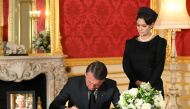 Brazilian President Jair Bolsonaro and First Lady Michelle de Paula Bolsonaro sign a book of condolence at Lancaster House in London, following the death of Queen Elizabeth II, on September 18, 2022. Jonathan Hordle/Pool via REUTERS