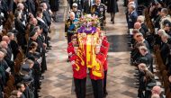 King Charles III, the Queen Consort, the Princess Royal, Vice Admiral Sir Tim Laurence, the Duke of York, the Earl of Wessex, the Countess of Wessex, the Prince of Wales, the Princess of Wales, Prince George, Princess Charlotte, the Duke of Sussex, the Duchess of Sussex, Peter Phillips and the Earl of Snowdon follow behind the coffin of Queen Elizabeth II, draped in the Royal Standard with the Imperial State Crown and the Sovereign's orb and sceptre, as it is carried out of Westminster Abbey after her State Funeral on September 19, 2022. Danny Lawson/Pool via REUTERS