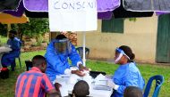 File Photo: Ugandan health workers speak to civilians before carrying out the first vaccination exercise against the Ebola virus in Kirembo village, near the border with the Democratic Republic of Congo in Kasese district, Uganda, on June 16, 2019. (REUTERS/James Akena)