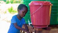 Photo: UNICEF Malawi 2022 (Elephant Media) - A 5-year-old boy washes his hands in Nedi Camp, Malawi.