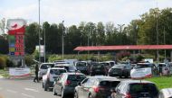  Car drivers queue to fill their fuel tanks at gasoline pumps at Auchan gas station in Petite-Foret, France, on October 6, 2022. REUTERS/Pascal Rossignol//File Photo