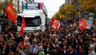 Demonstrators take part in a protest by New Ecologic and Social People's Union (NUPES), a coalition of left and green parties, against soaring inflation and what they call a lack of government action to fight climate change, in Paris, France, on October 16, 2022. REUTERS/Stephane Mahe