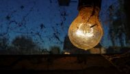 An incandescent light bulb is covered in spider webs inside a stable in Vasilati, Calarasi county, 30 kilometers from Bucharest, Romania, October 17, 2022. Inquam Photos/Octav Ganea via REUTERS
