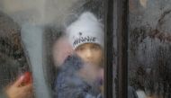 A boy evacuated from the Russian-controlled city of Kherson looks on in a bus heading to Crimea, in the town of Oleshky, Kherson region, Russian-controlled Ukraine October 23, 2022. (REUTERS/Alexander Ermochenko)