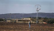 A guardia civil officer inspects the burn field where Angel Martin suffered grave burnt injuries yesterday while trying to tackle the fire on a wheat field in Tabara, Spain, July 19, 2022. REUTERS/Isabel Infantes/File Photo