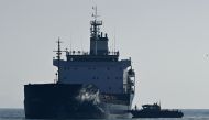 A photograph taken on October 31, 2022 shows a cargo ship loaded with grain being inspected in the anchorage area of the southern entrance to the Bosphorus in Istanbul. Photo by Ozan Kose / AFP
 