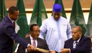 Ethiopian government representative Redwan Hussien and Tigray delegate Getachew Reda pass documents during the signing of the AU-led negotiations to resolve the conflict in northern Ethiopia, in Pretoria, South Africa, November 2, 2022. (REUTERS/Siphiwe Sibeko/)