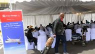A passenger approaches a Kenya Airways help desk that assists travelling passengers to re-book flights and hotels, on the second day of a strike by pilots organised by Kenya Airline Pilots Association, at the Jomo Kenyatta International airport in Nairobi on November 6, 2022. (AFP/ Simon Maina)