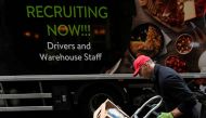 A lorry driver passes a sign on the side of his vehicle advertising for jobs as he makes a delivery, in London, Britain, on October 13, 2021. File Photo / Reuters