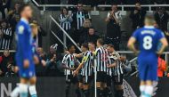 Newcastle United's English midfielder Joe Willock celebrates scoring his team's first goal with teammates during the English Premier League football match between Newcastle United and Chelsea at St James' Park in Newcastle-upon-Tyne, north east England on November 12, 2022. (Photo by ANDY BUCHANAN / AFP)