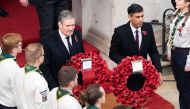 Britain's main opposition Labour Party leader Keir Starmer (left) and Britain's Prime Minister Rishi Sunak come out to lay wreaths at The Cenotaph during the Remembrance Sunday ceremony on Whitehall in central London, on November 13, 2022.  (Photo by Stefan Rousseau / POOL / AFP)