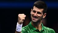 Serbia's Novak Djokovic celebrates after winning his first round-robin match against Greece's Stefanos Tsitsipas at the ATP Finals tennis tournament on November 14, 2022 in Turin. (Photo by Marco BERTORELLO / AFP)

