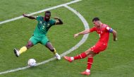 Switzerland's Granit Xhaka in action with Cameroon's Nicolas Nkoulou during the Qatar 2022 World Cup Group G football match between Switzerland and Cameroon at the Al-Janoub Stadium in Al-Wakrah, south of Doha on November 24, 2022. (Photo by Glyn KIRK / AFP)