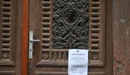 An information paper reading 'The central library is closed from November 1' hangs on the main entrance of the library in Szekesfehervar, Hungary, on November 9, 2022. Photo by Attila Kisbenedek / AFP