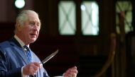 Britain's King Charles III cuts a cake to celebrate the 40th anniversary of Business in the Community (BITC), at the Central Hall Westminster in London, Britain, December 7, 2022. (Kin Cheung/Pool via REUTERS)