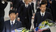 Japan’s head coach Hajime Moriyasu (left) and player Maya Yoshida arrive at Narita Airport in Narita, on Wednesday. AFP