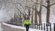 A police officer walks on the street as cold weather continues, in London, Britain, December 12, 2022. REUTERS/Toby Melville