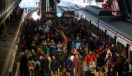 Commuters get on and off their trains at Madrid's Atocha station March 11, 2014. REUTERS/Andrea Comas/File Photo