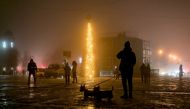 People walk past a Christmas tree during heavy fog at the Sofiyska square, amid Russia's invasion of Ukraine, in Kiev, Ukraine December 17, 2022. REUTERS/Vladyslav Musiienko TPX IMAGES OF THE DAY
