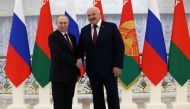 Russian President Vladimir Putin and Belarusian President Alexander Lukashenko shake hands before their meeting at the Palace of Independence in Minsk, Belarus on December 19, 2022. Sputnik/Konstantin Zavrazhin/Pool via REUTERS 