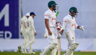 India's Nazmul Hasan Santo (L) and Zakir Hasan (R) walk off the field after the second day of the second cricket Test match between Bangladesh and India on December 23, 2022. (Photo by Munir uz Zaman / AFP)