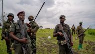 M23 rebels look on in Kibumba in eastern Democratic Republic of Congo, on December 23, 2022.  (Photo by GLODY MURHABAZI / AFP)