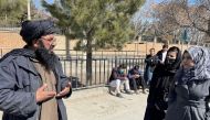 A member of Taliban speaks with female students outside the Kabul Education University in Kabul, Afghanistan, on February 26, 2022. File Photo / Reuters