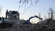 Workers dismantle a heavily damaged residential building in Irpin, northwest of Kyiv, on December 23, 2022, amid the Russian invasion of Ukraine. (Photo by Genya SAVILOV / AFP)