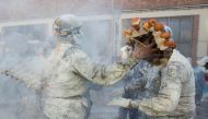 Revellers dressed in mock military garb take part in 'Els Enfarinats' food-battle in the southeastern Spanish town of Ibi on December 28, 2022. (Photo by Jaime Reina / AFP)