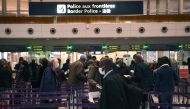 In this file photo taken on February 1, 2021, travellers queue at the immigration desk of Roissy Charles-de-Gaulle international airport, as new Covid-19 border restrictions come into effect.  (Photo by Christophe ARCHAMBAULT / AFP)