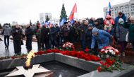 Mourners gather to lay flowers in memory of more than 60 Russian soldiers that Russia says were killed in a Ukrainian strike on Russian-controlled territory, in Samara, on January 3, 2023.  (Photo by Arden Arkman / AFP)