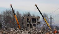 Workers remove debris of a destroyed building purported to be a vocational college used as temporary accommodation for Russian soldiers, dozens of whom were killed in a Ukrainian missile strike, January 4, 2023. Reuters/Alexander Ermochenko