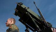 In this file photo taken on March 25, 2014, a German soldier stands to attention in front of a German Patriot missile launcher at the Gazi barracks in Kahramanmaras, southern Turkey, on March 25, 2014. (Photo by John MacDougall / AFP)