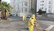 Municipality employees cleaning a road.