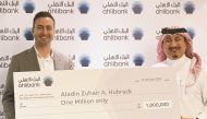 Aladin Hubrack receives the prize from Mohamed Al Namla, Deputy CEO Business Support, Services and Human Resources at Ahlibank.