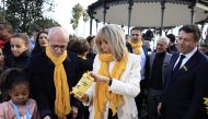 French President's wife Brigitte Macron (centre) and Nice Mayor Christian Estrosi (right) attend the opening of the 2023 edition of the 