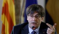 File Photo: Catalan separatist leader Carles Puigdemont delivers remarks to the media after the first hearing on his European arrest warrant, in Alghero, Italy, October 4, 2021. (REUTERS/Guglielmo Mangiapane)