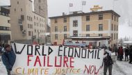 Climate activists display a banner during a protest ahead of the World Economic Forum (WEF) 2023 in the Alpine resort of Davos, Switzerland, January 15, 2023. (REUTERS/Arnd Wiegmann)