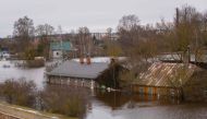 Flooded houses are pictured in Jekabpils, Latvia, on January 15, 2023. (Photo by Gints Ivuskans / AFP)