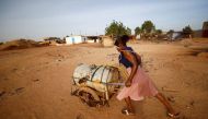 A woman pushes a barrel filled with water on the outskirts of Ouagadougou, Burkina Faso on January 30, 2022. File Photo / Reuters